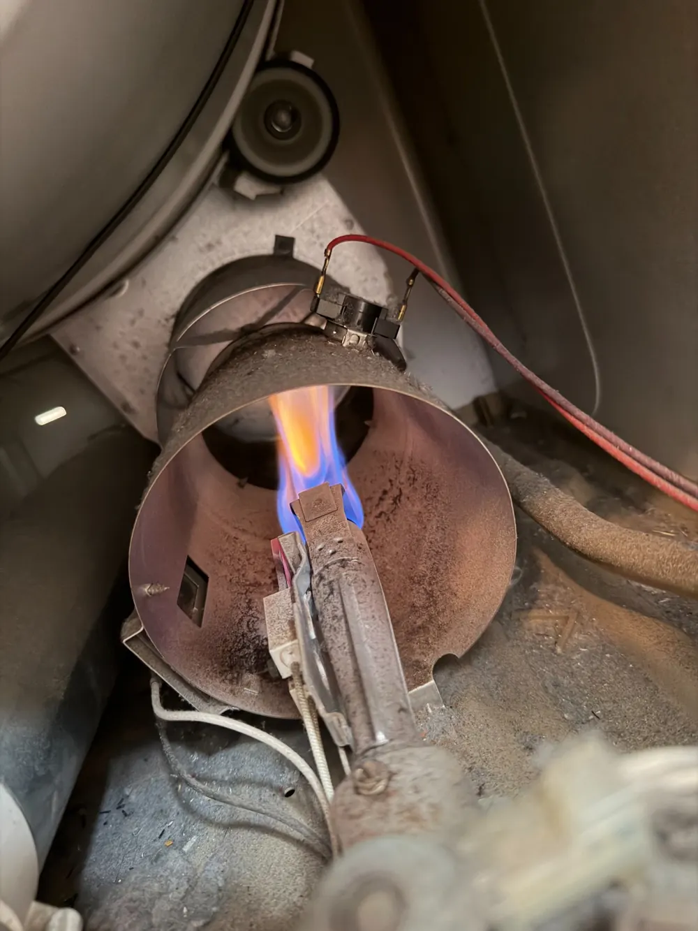 Gas dryer burner showing weak flame before gas valve coil replacement