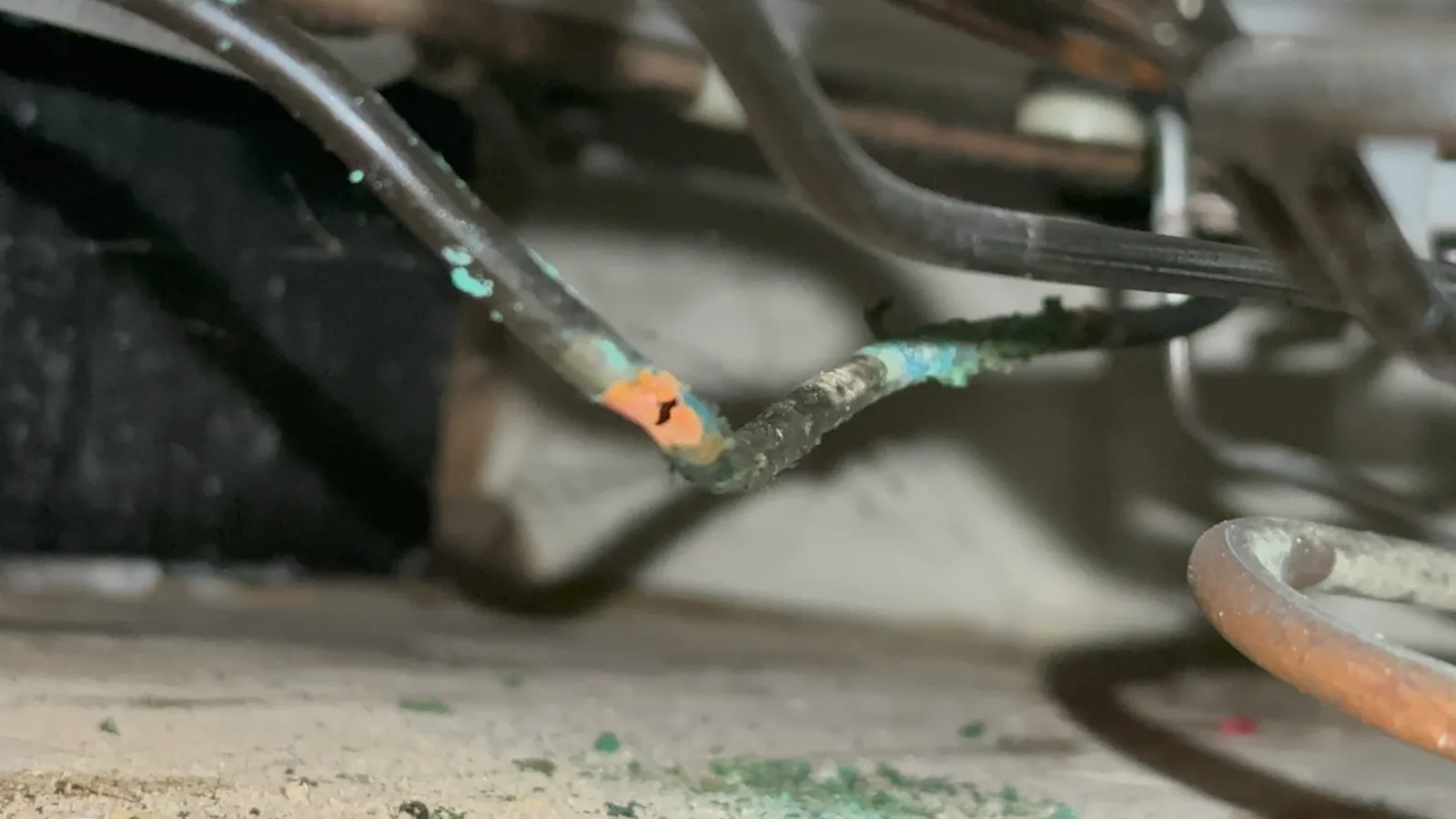 Corroded copper refrigerant tubing with a leak in a Sub-Zero sealed system