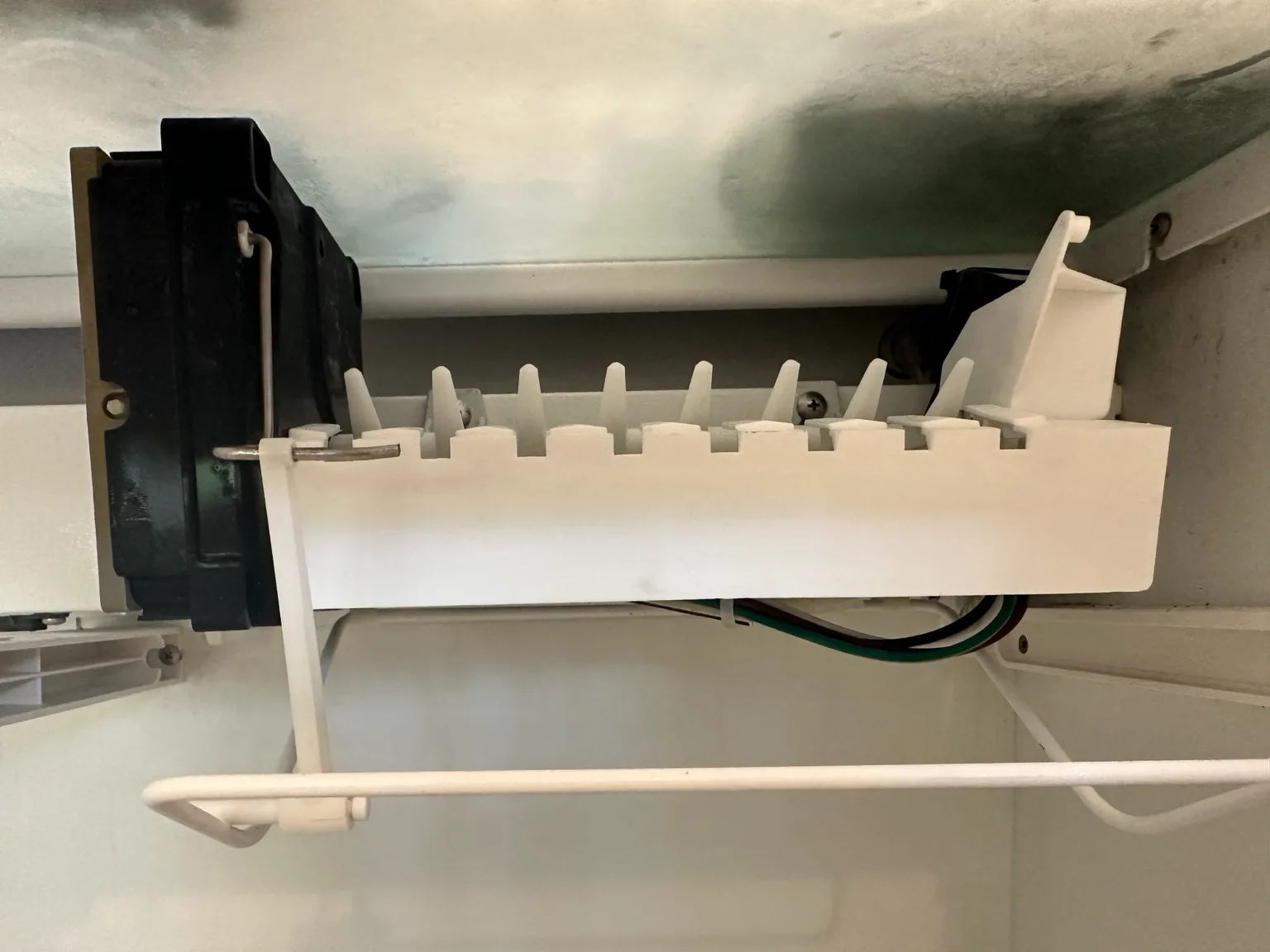 Sub-Zero ice maker assembly exposed for diagnosis and repair