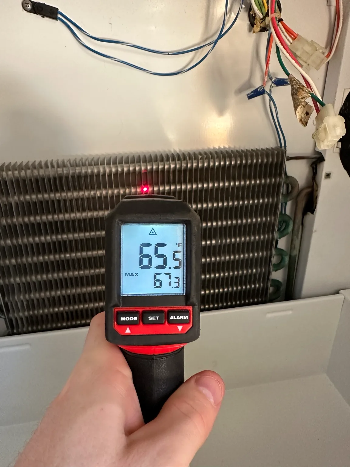 Infrared thermometer showing about 65 degrees inside a warm Sub-Zero refrigerator